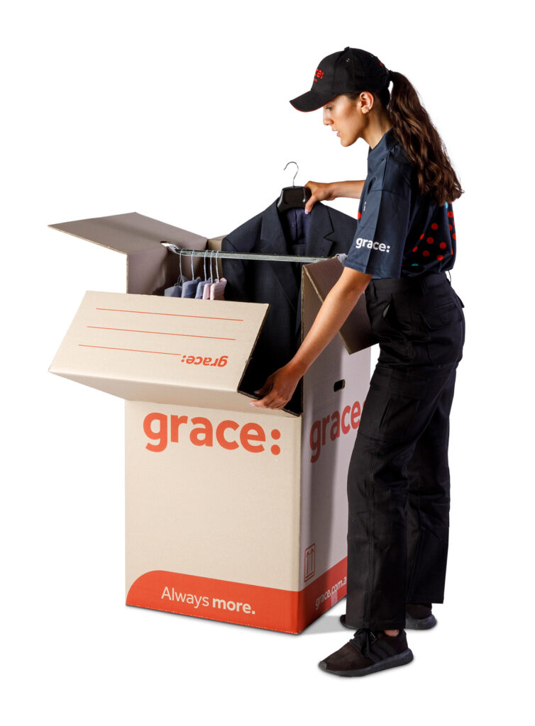 Grace employee packing suits into a box